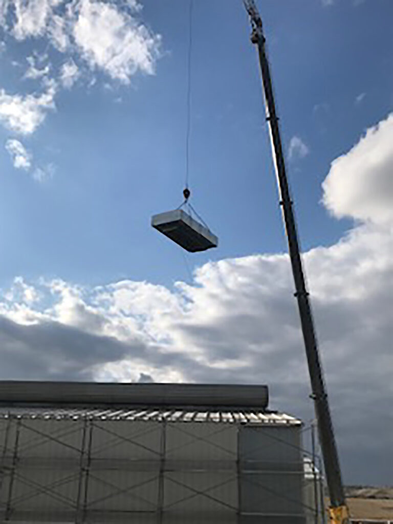 crane holding metal hvac